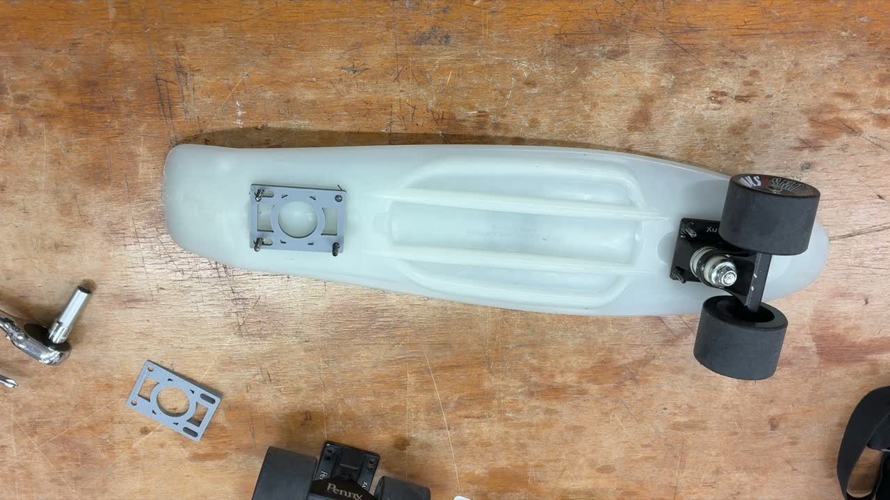 Cruiser deck with trucks, wheels and riser hardware laid out