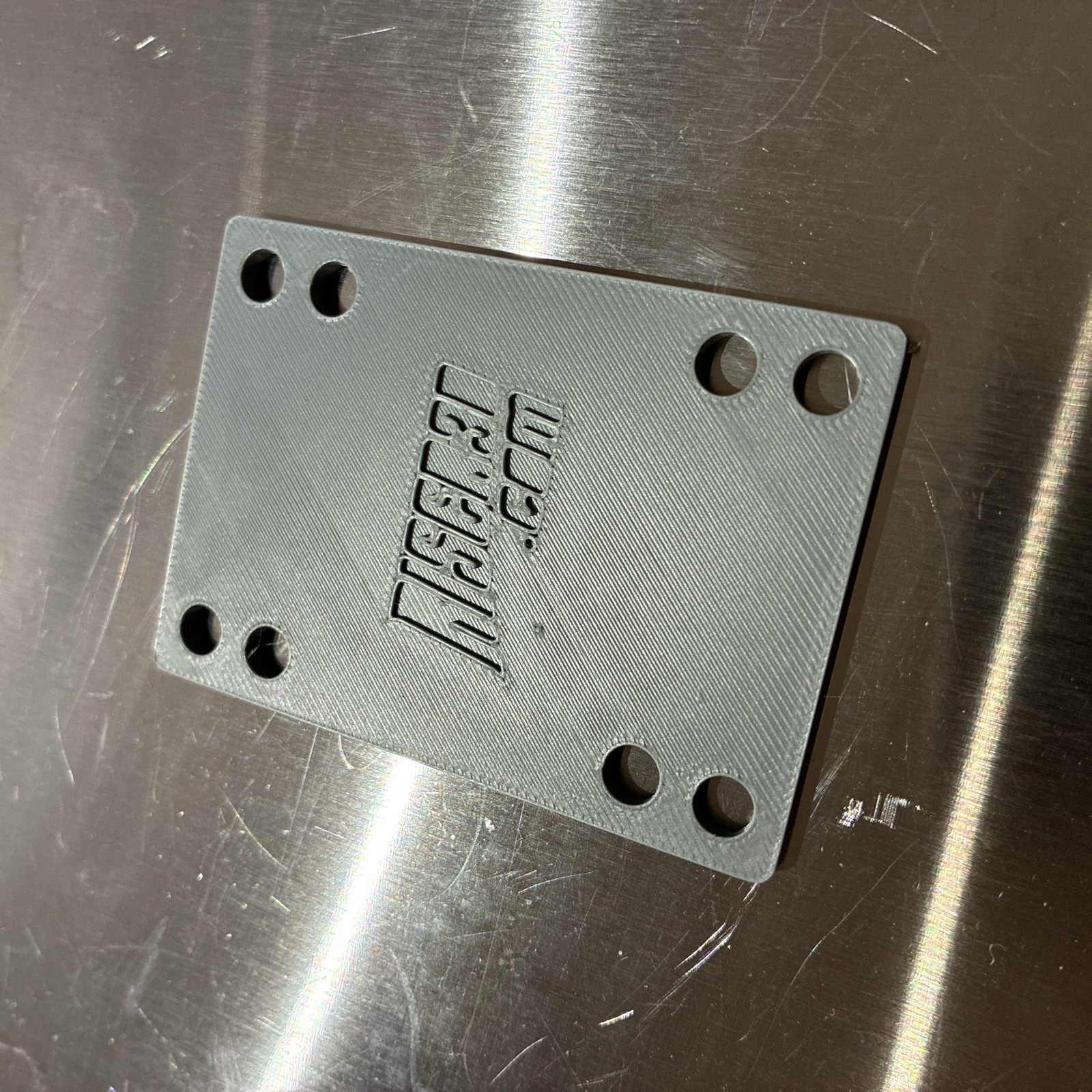 3D printed skateboard riser pad with riser3d.com logo, printed in PETG