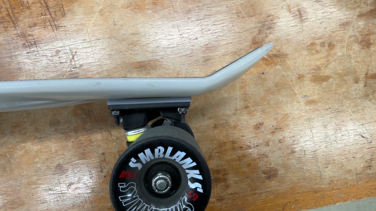 Skateboard side profile showing wheel-to-deck clearance created by a riser pad
